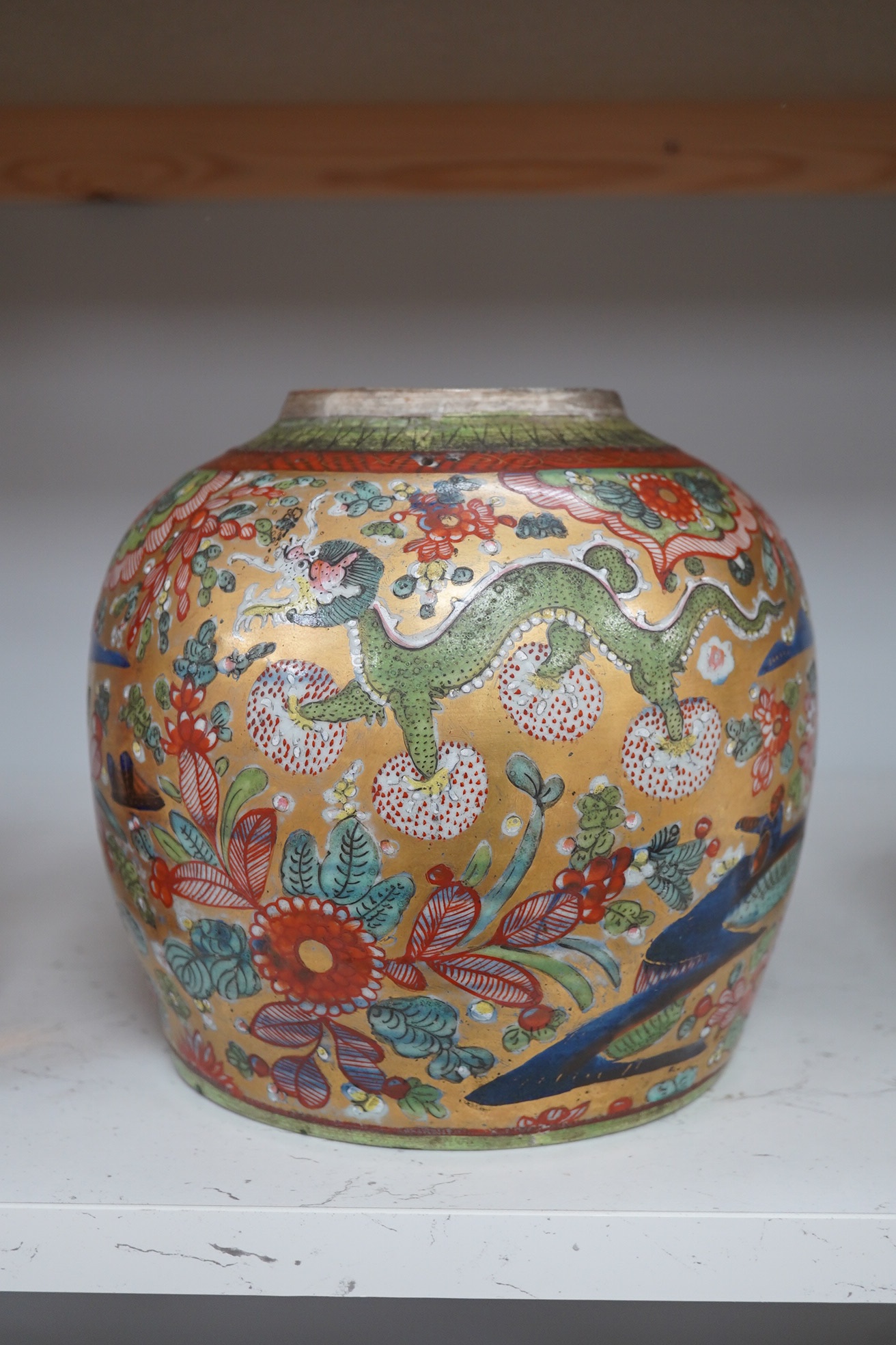 A Chinese porcelain clobbered ginger jar, with gold ground and dragon decoration, 20cm high. Condition - fair, minor wear /damage and a hole drilled near the rim